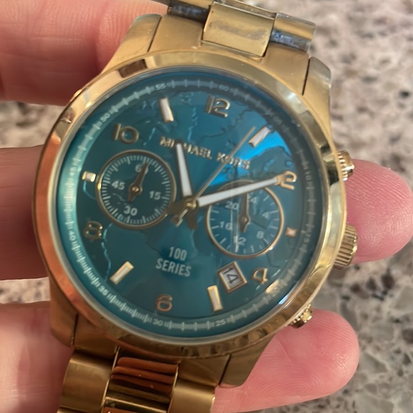 Gold watch with Turquoise face. Good condition